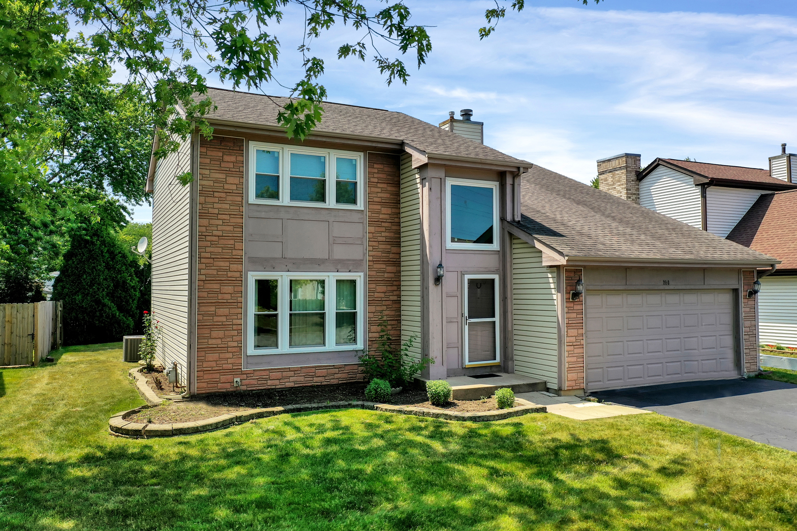 700 Greenview Lane Wheeling, IL 60090 - Photo 2 of 26 a front view of a house with a yard