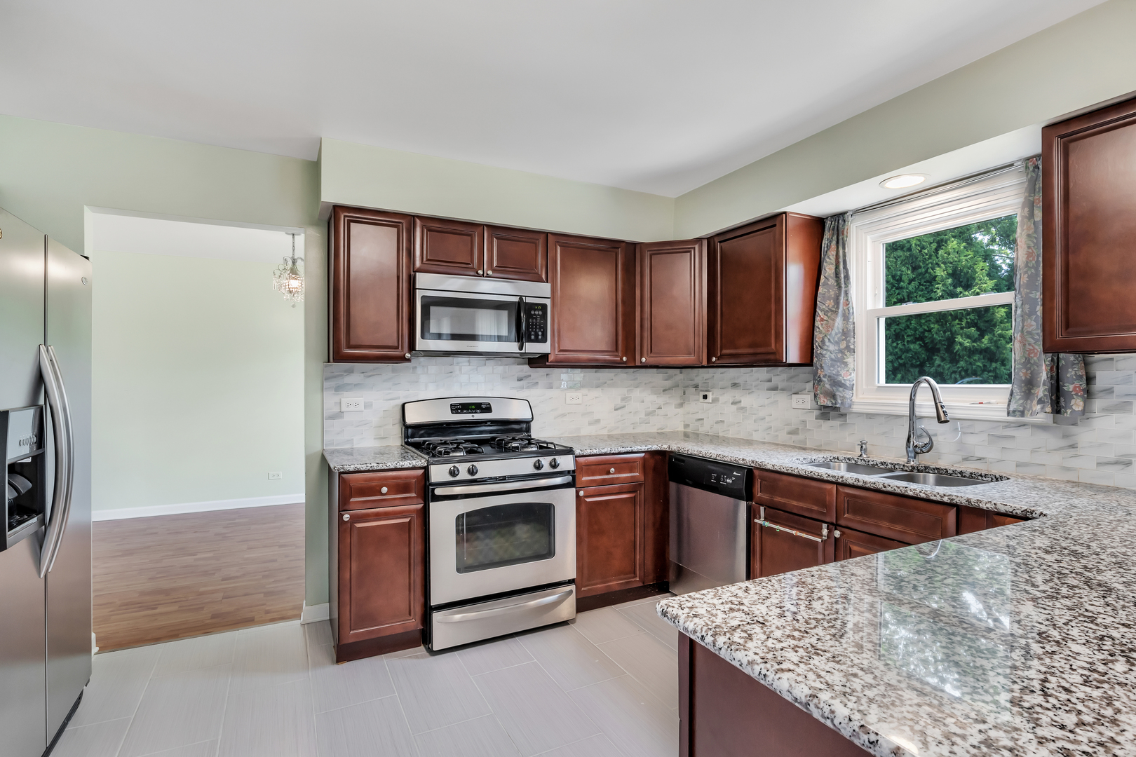 700 Greenview Lane Wheeling, IL 60090 - Photo 5 of 26 a kitchen with stainless steel appliances granite countertop a stove a sink dishwasher a refrigerator and a microwave oven