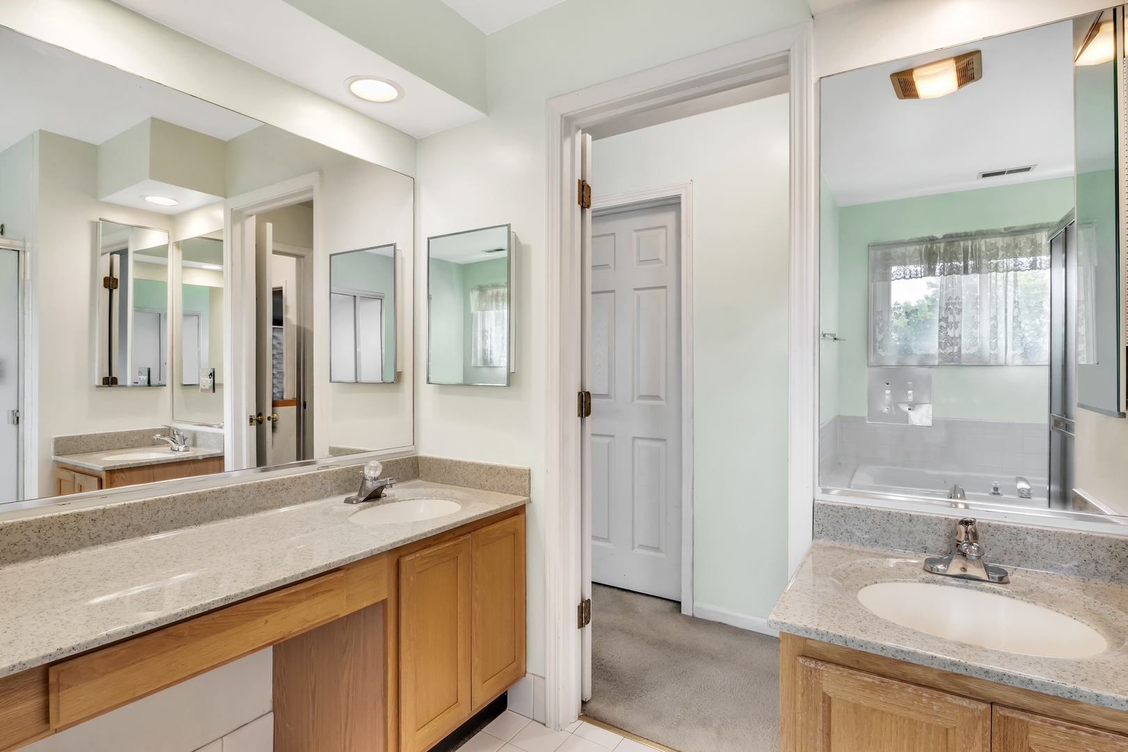 700 Greenview Lane Wheeling, IL 60090 - Photo 10 of 26 a bathroom with a sink double vanity and a mirror