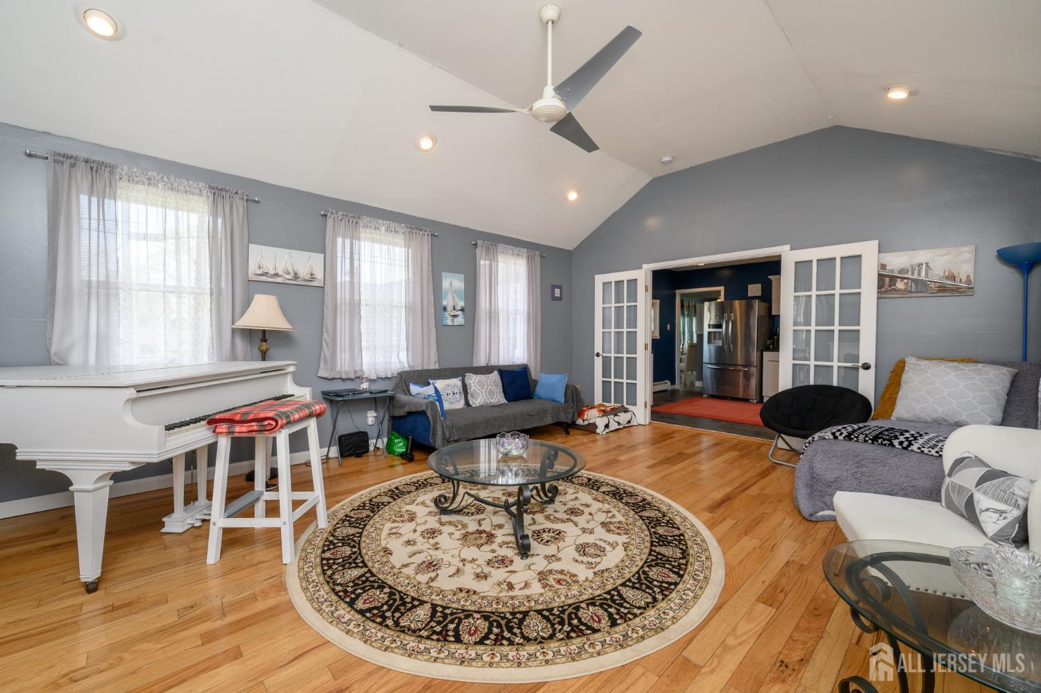 39 East 2nd Avenue Runnemede, NJ 08078 - Photo 14 of 41 a living room with furniture a wooden floor and a chandelier