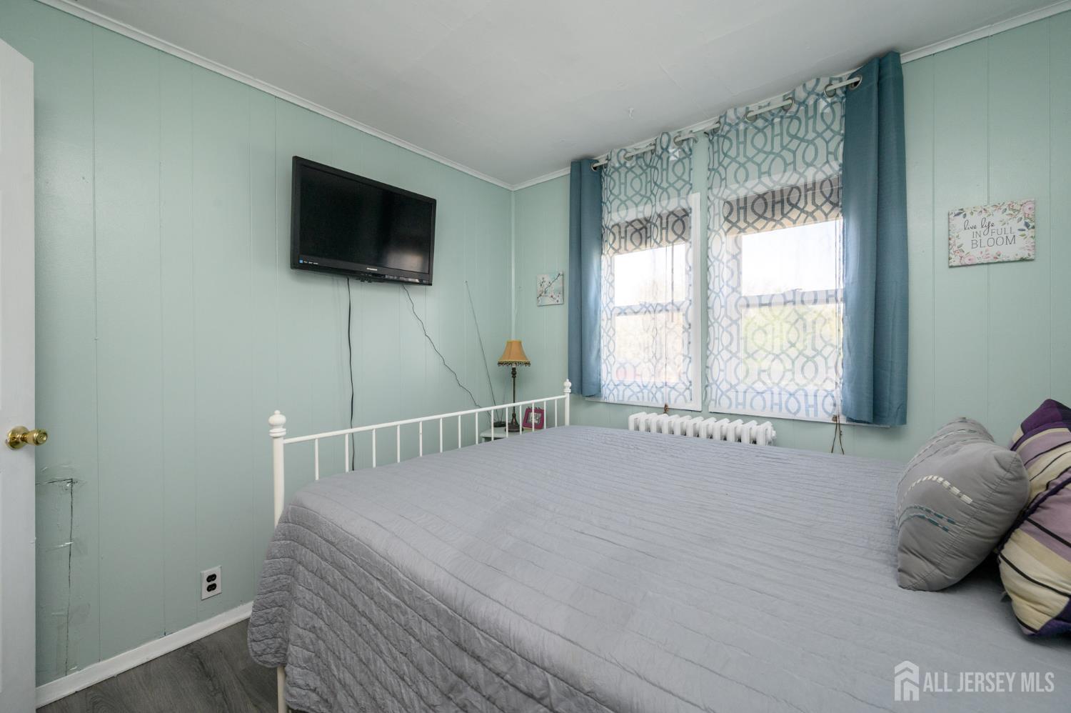 39 East 2nd Avenue Runnemede, NJ 08078 - Photo 19 of 41 a bedroom with a bed and a flat tv screen on the dresser