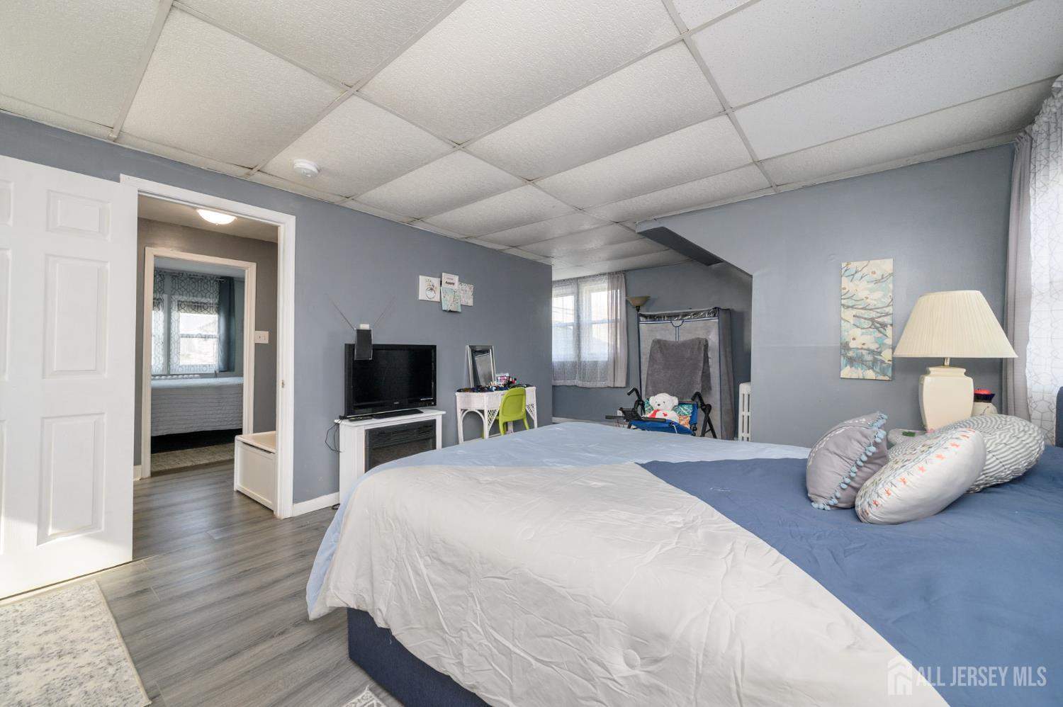 39 East 2nd Avenue Runnemede, NJ 08078 - Photo 23 of 41 a spacious bedroom with a bed and a flat screen tv