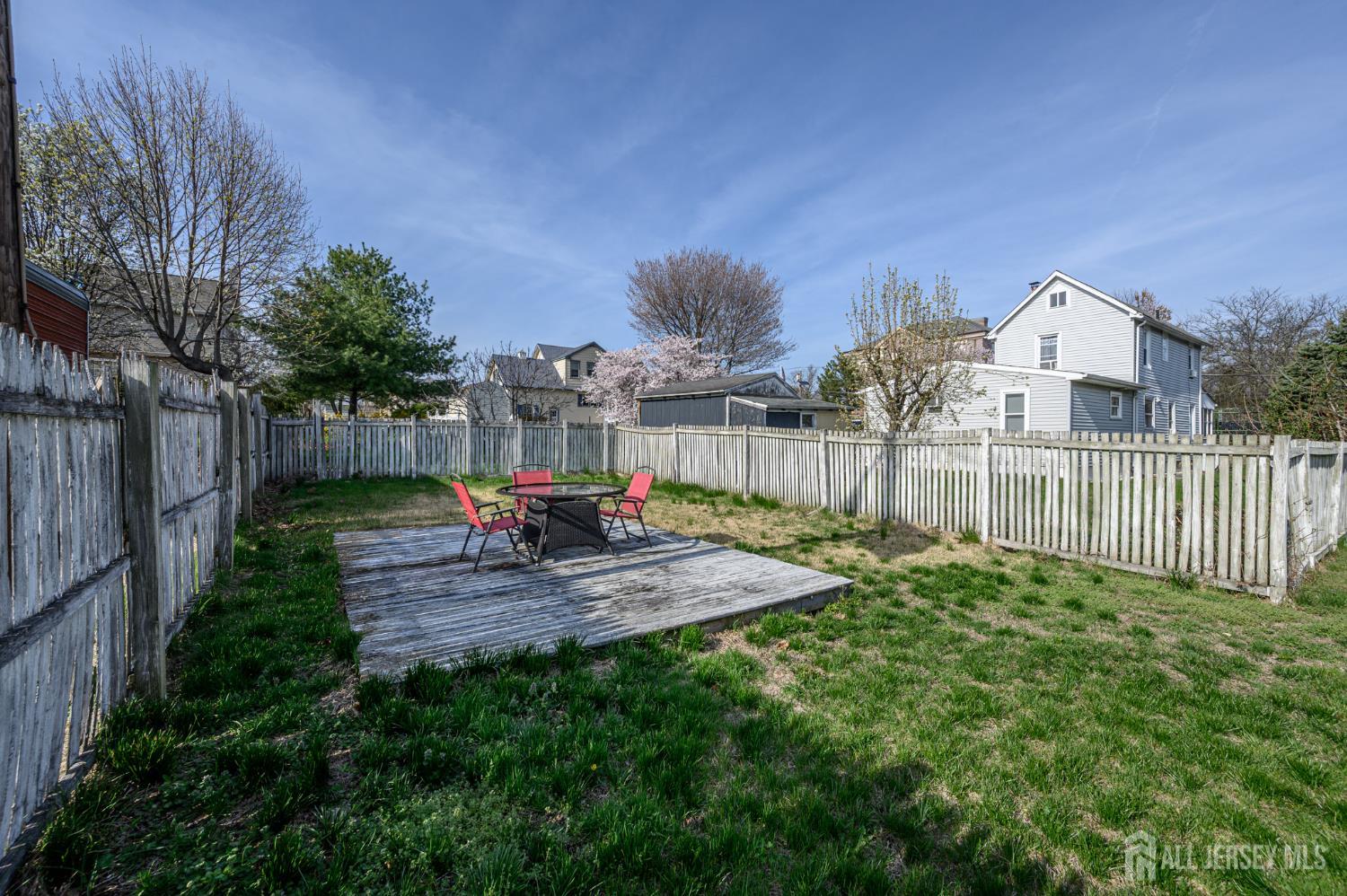 39 East 2nd Avenue Runnemede, NJ 08078 - Photo 33 of 41 a view of a backyard with table and chairs a barbeque and wooden fence