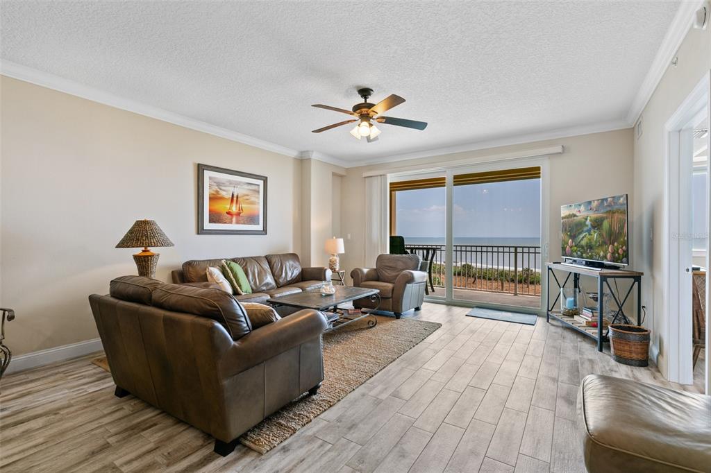 60 Surfview Drive, Unit 502 Palm Coast, FL 32137 - Photo 11 of 63 a living room with furniture and a wooden floor