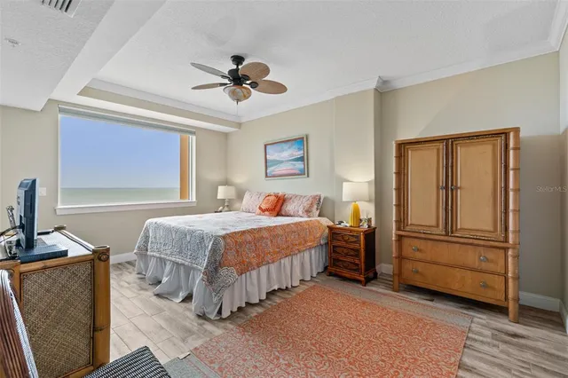 a bedroom with a bed a dresser and chair