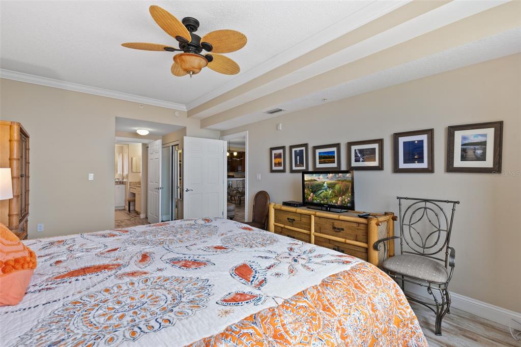 60 Surfview Drive, Unit 502 Palm Coast, FL 32137 - Photo 21 of 63 a bedroom with a bed a dresser and chair