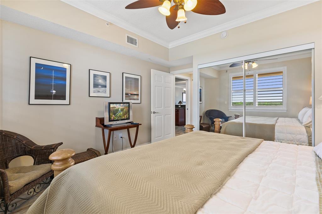 60 Surfview Drive, Unit 502 Palm Coast, FL 32137 - Photo 25 of 63 a bedroom with a bed and dresser with wooden floor