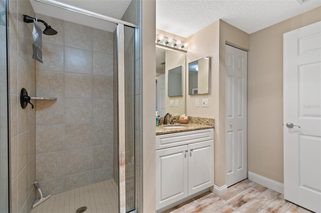 60 Surfview Drive, Unit 502 Palm Coast, FL 32137 - Photo 26 of 63 a bathroom with a shower sink and mirror