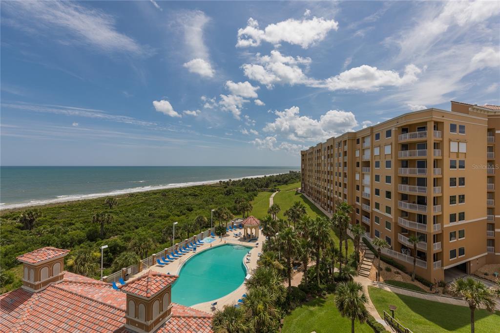 60 Surfview Drive, Unit 502 Palm Coast, FL 32137 - Photo 30 of 63 a view of a swimming pool with outdoor seating and plants