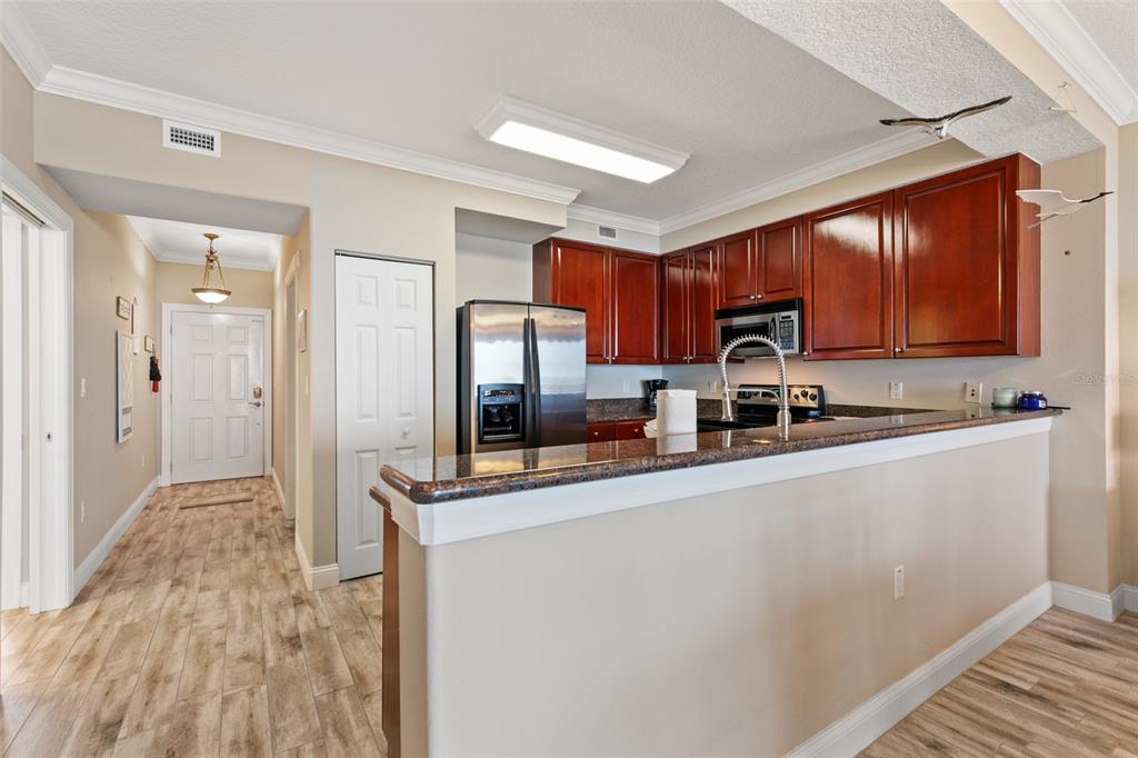 60 Surfview Drive, Unit 502 Palm Coast, FL 32137 - Photo 3 of 63 a kitchen with stainless steel appliances a sink stove refrigerator and cabinets