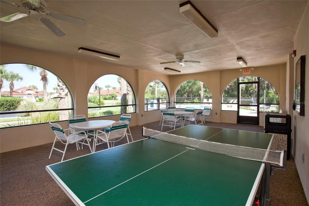 60 Surfview Drive, Unit 502 Palm Coast, FL 32137 - Photo 48 of 63 a view of a swimming pool with a dining table and chairs