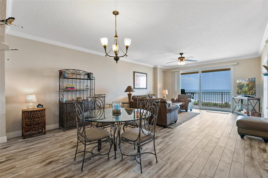 60 Surfview Drive, Unit 502 Palm Coast, FL 32137 - Photo 7 of 63 a view of a dining room with furniture wooden floor and chandelier
