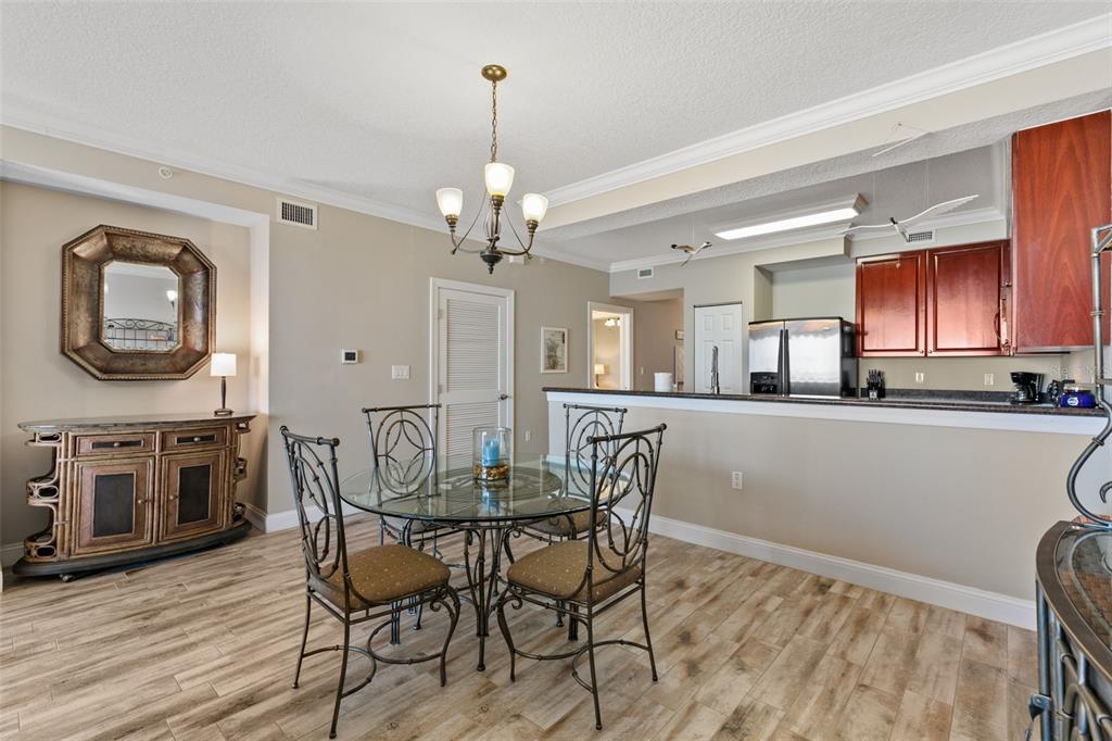 60 Surfview Drive, Unit 502 Palm Coast, FL 32137 - Photo 9 of 63 a view of a dining room with furniture and wooden floor