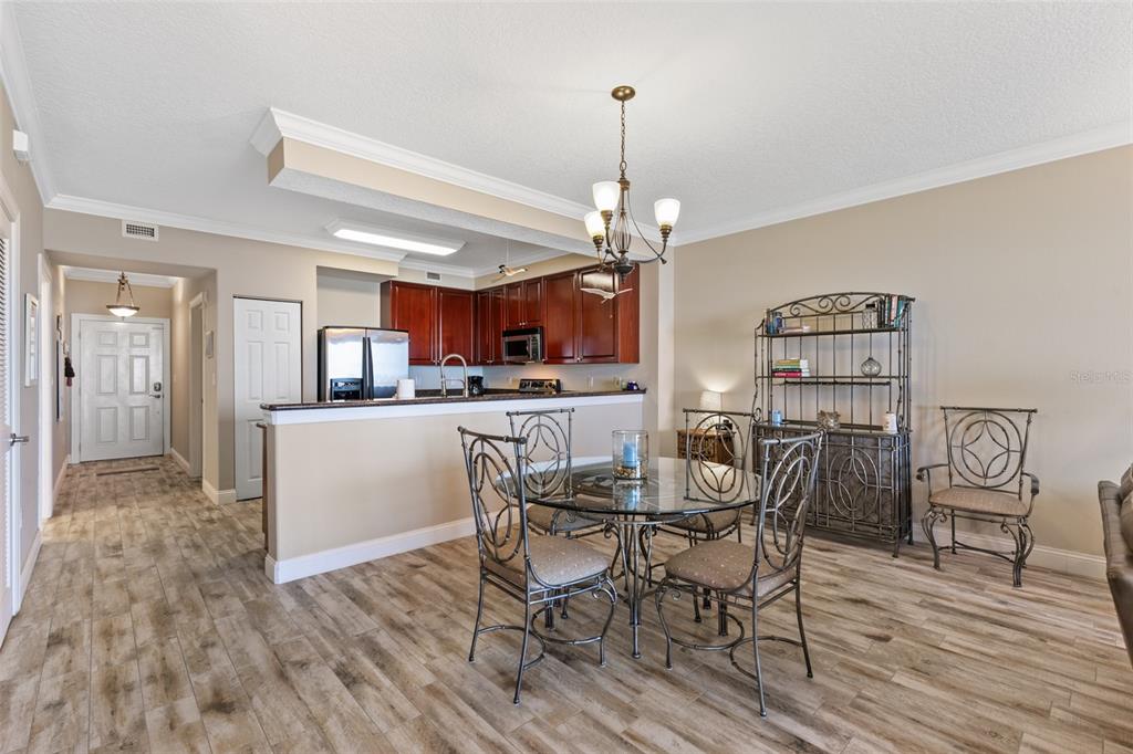 60 Surfview Drive, Unit 502 Palm Coast, FL 32137 - Photo 10 of 63 a view of a dining room with furniture and wooden floor