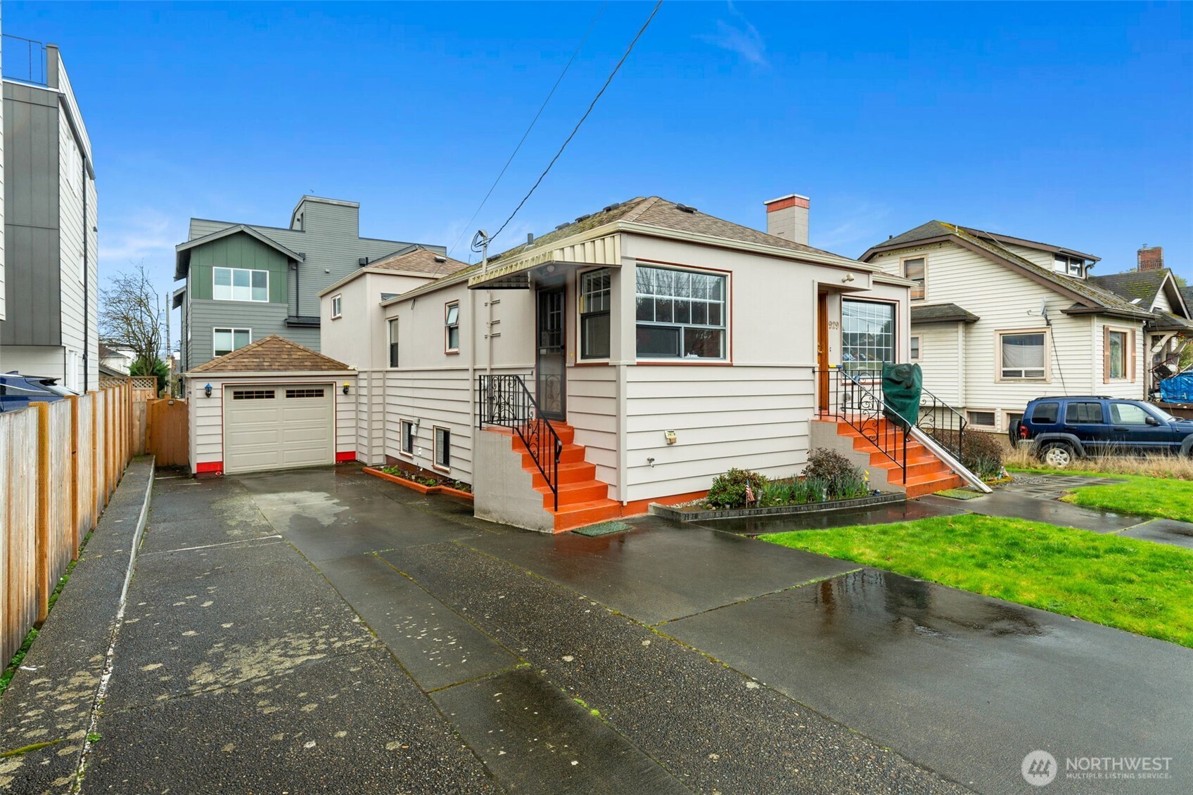 929 Northwest 59th Street Seattle, WA 98107 - Photo 2 of 38 a front view of a house with a yard and garage