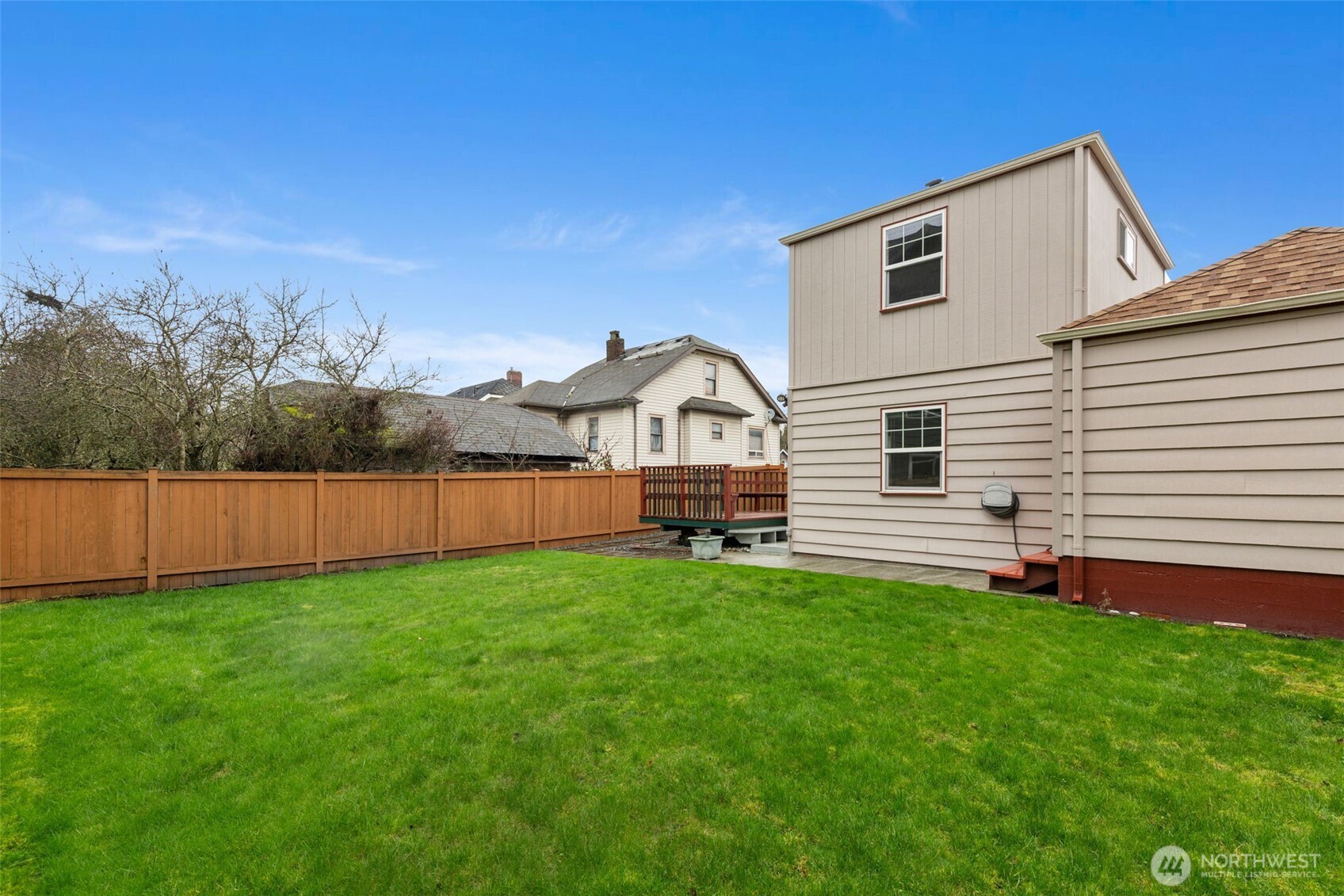 929 Northwest 59th Street Seattle, WA 98107 - Photo 35 of 38 a view of a house with a yard and wooden fence