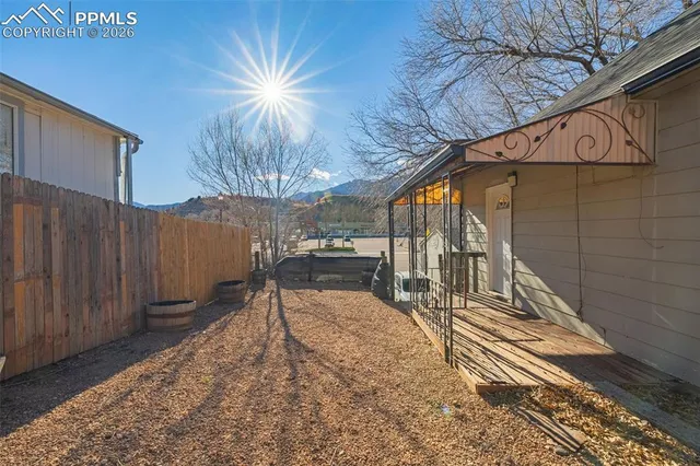 a yellow house with trees in front of it