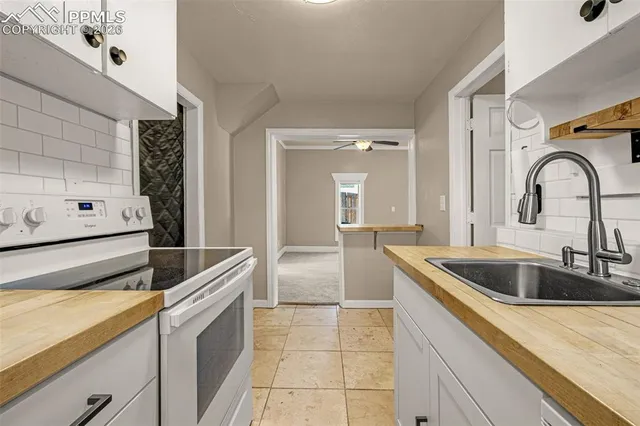 a kitchen with a sink and a stove top oven