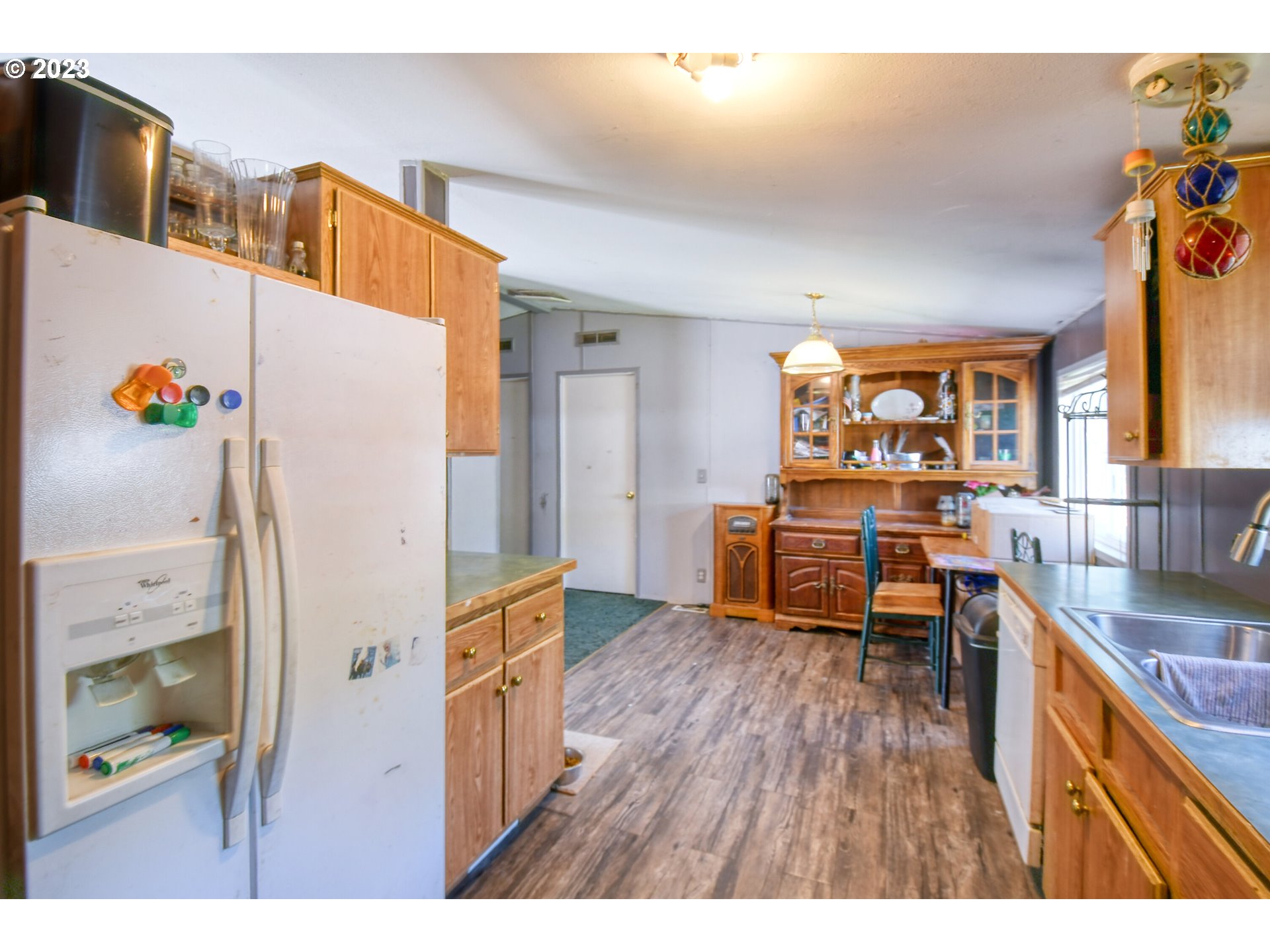 1437 Southwest 37th Street, Unit 14 Pendleton, OR 97801 - Photo 8 of 14 a kitchen that has a lot of cabinets a sink and wooden floor