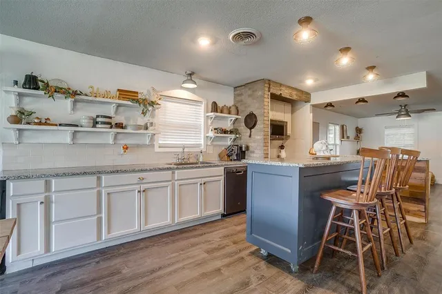 a kitchen with stainless steel appliances granite countertop a stove and a microwave
