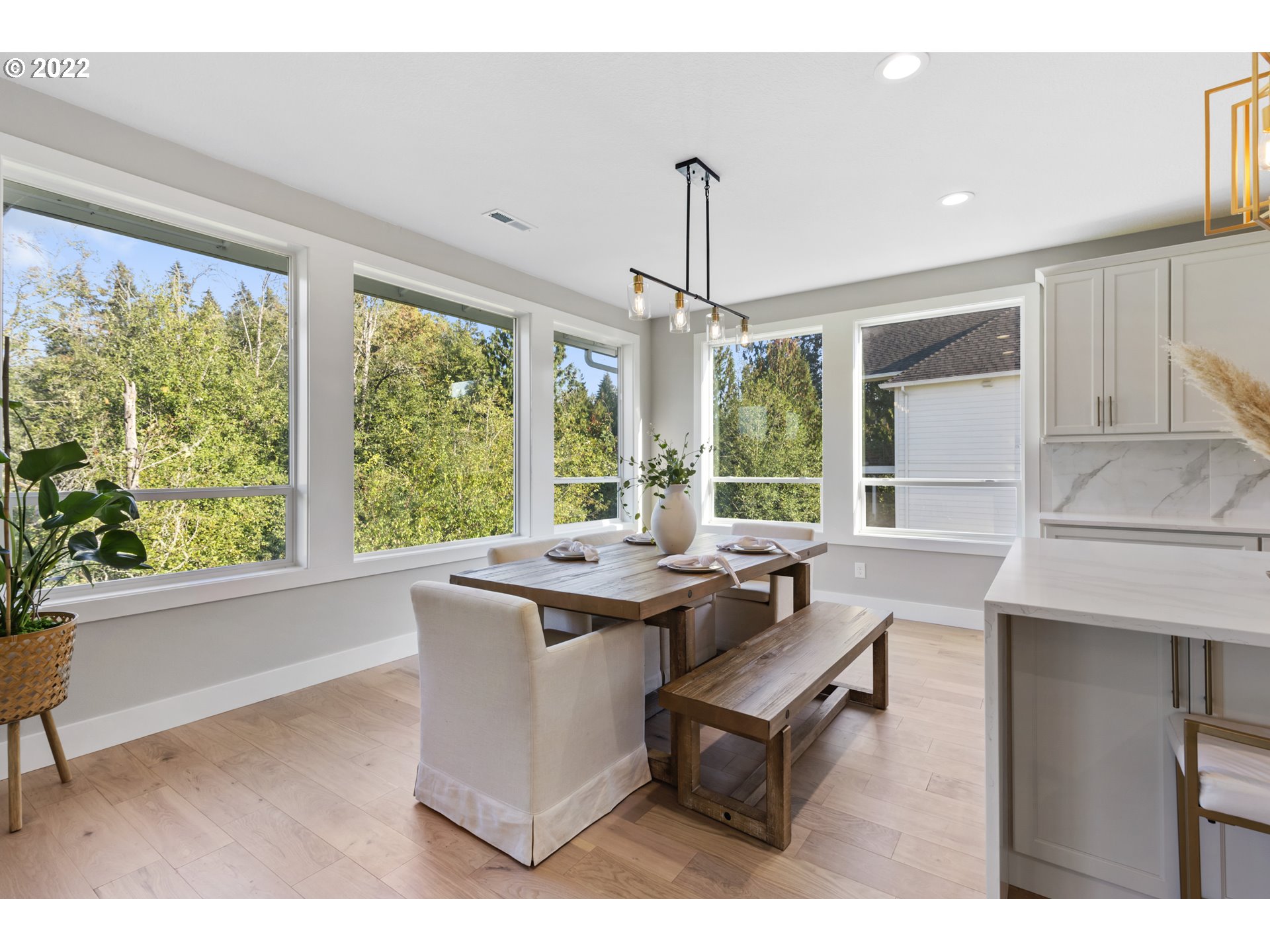 700 South 19th Place Ridgefield, WA 98642 - Photo 17 of 32 a dining room with a table chairs and a large window