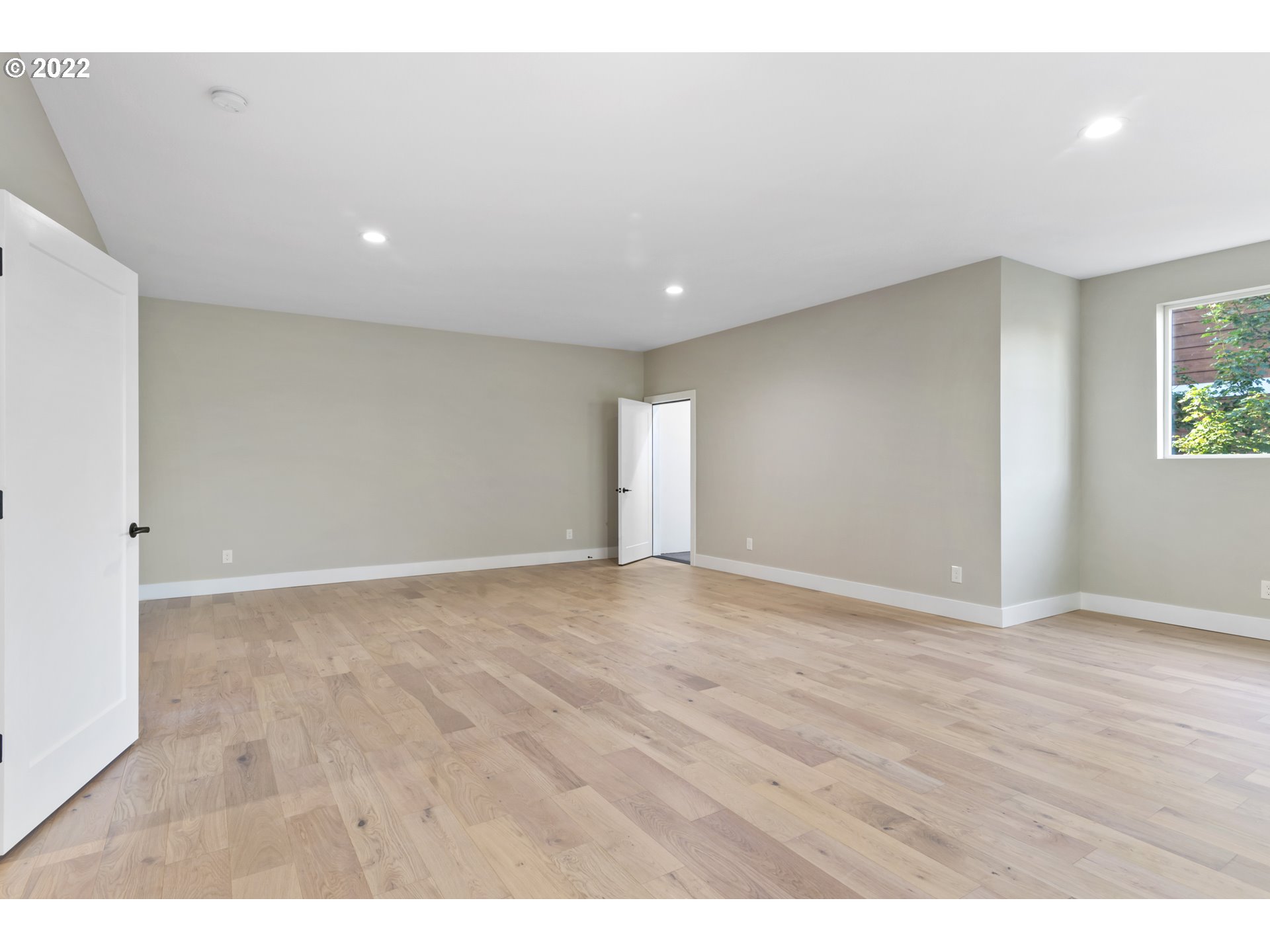700 South 19th Place Ridgefield, WA 98642 - Photo 27 of 32 a view of an empty room with wooden floor and a window