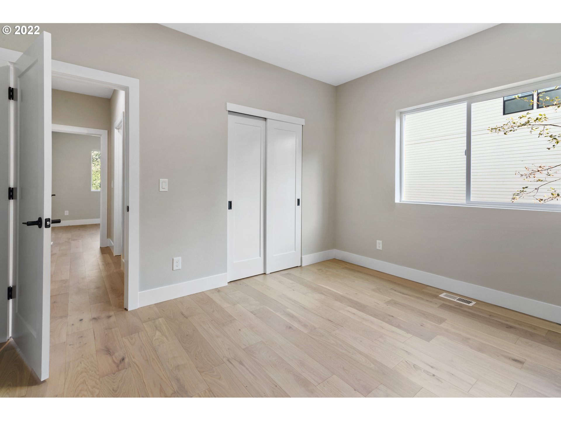 700 South 19th Place Ridgefield, WA 98642 - Photo 29 of 32 a view of an empty room with wooden floor and a window