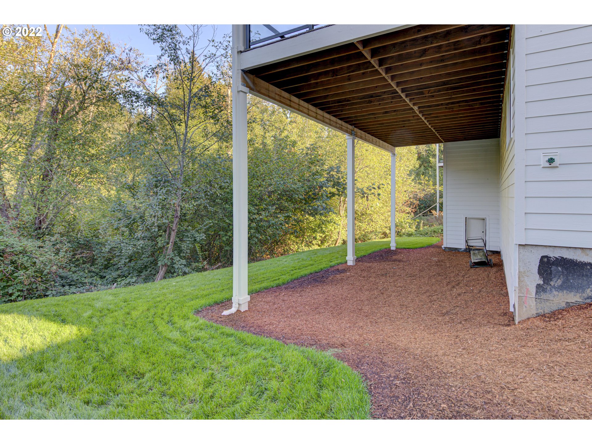 700 South 19th Place Ridgefield, WA 98642 - Photo 32 of 32 a view of a backyard with floor to ceiling window and tree