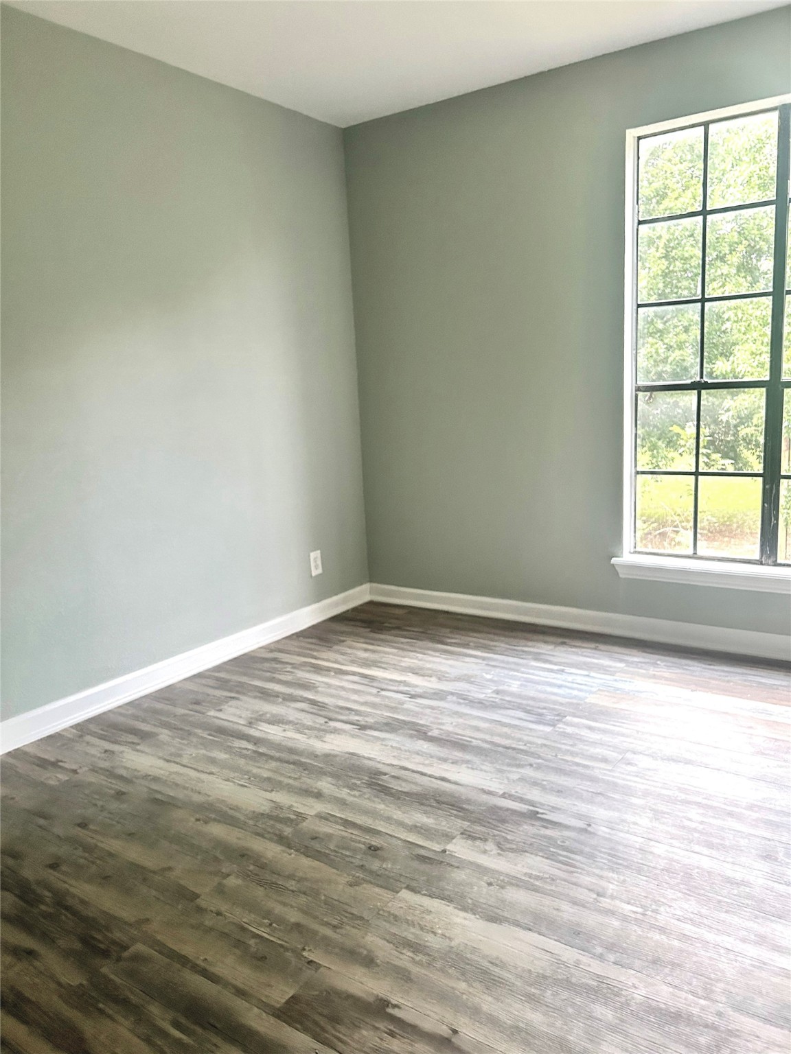 4622 Hill Side Lane Needville, TX 77461 - Photo 19 of 19 wooden floor in an empty room with a window