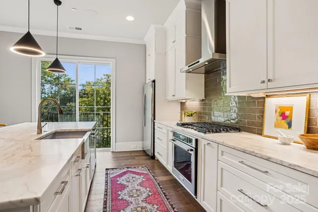 a kitchen with a stove a sink and a refrigerator