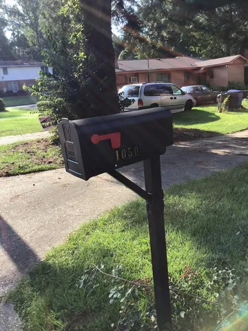 a view of a backyard with table and chairs potted plants with wooden fence