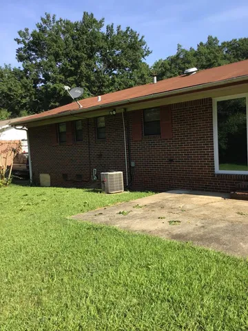 a side view of a house with a yard