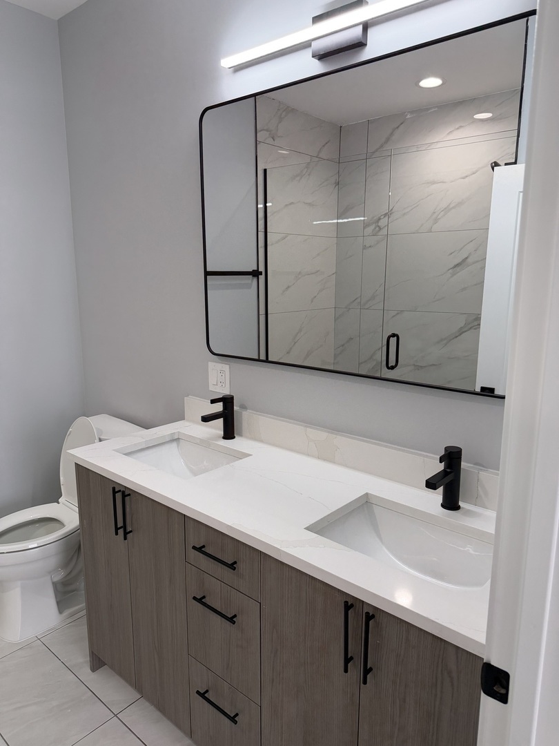 2622 West Adams Street, Unit 3 Chicago, IL 60612 - Photo 14 of 26 a bathroom with a sink and a mirror