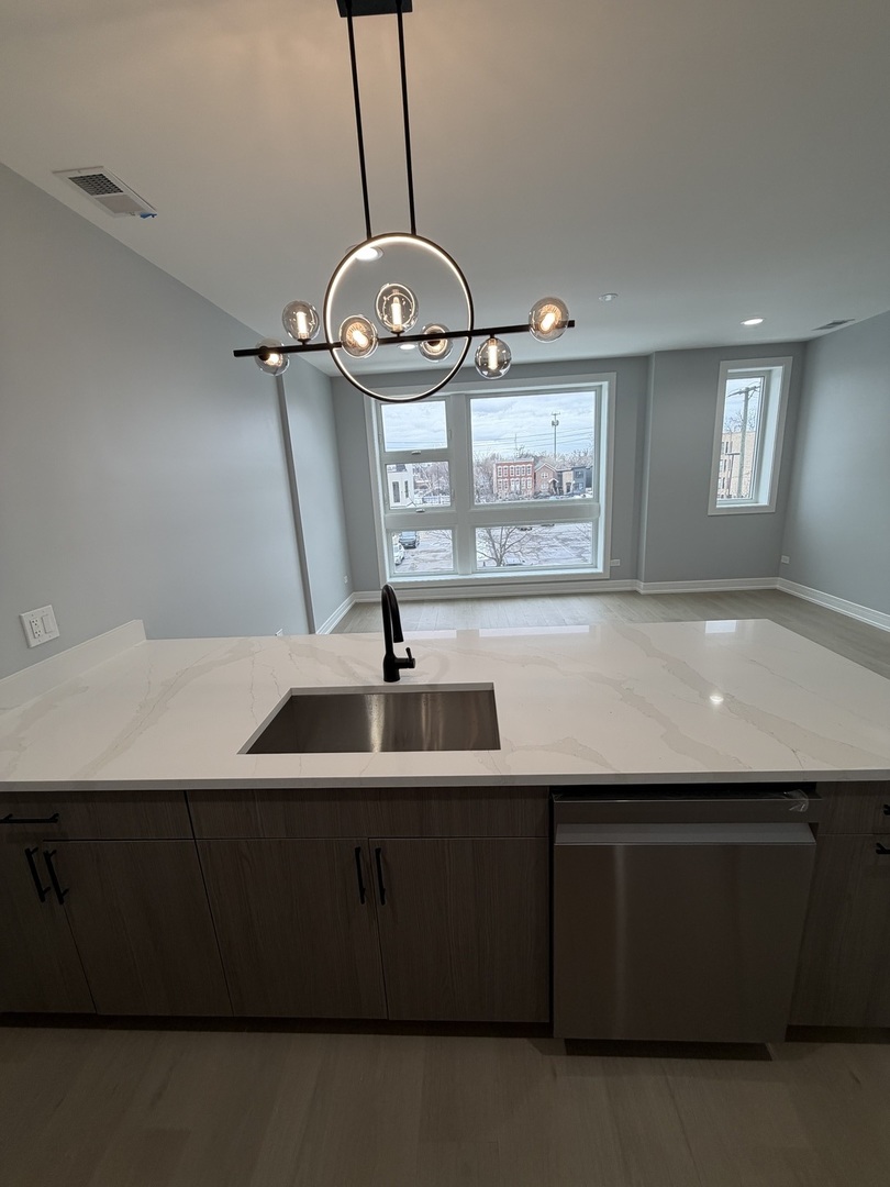 2622 West Adams Street, Unit 3 Chicago, IL 60612 - Photo 10 of 26 a view of a room with a sink and mirror