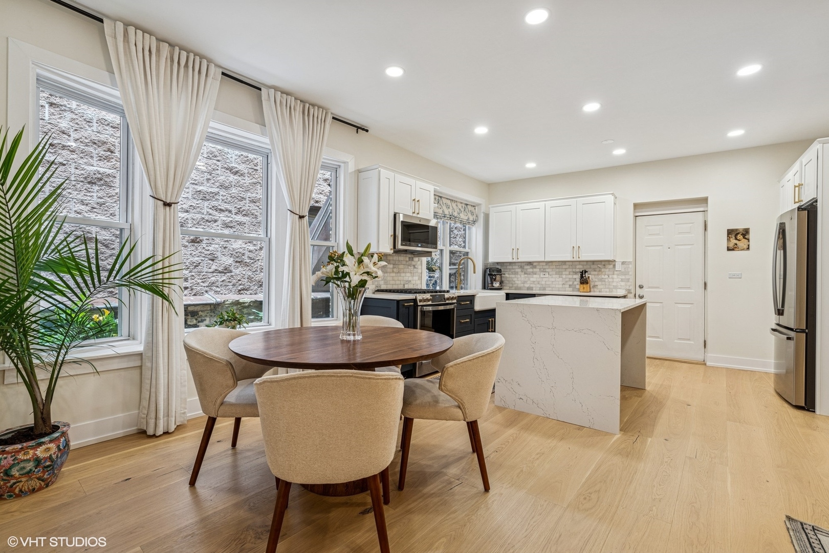 5103 North Clark Street, Unit 2 Chicago, IL 60640 - Photo 2 of 21 a living room with stainless steel appliances kitchen island granite countertop furniture and a kitchen view