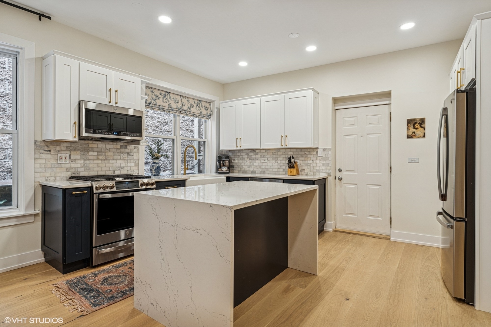 5103 North Clark Street, Unit 2 Chicago, IL 60640 - Photo 3 of 21 a kitchen with stainless steel appliances granite countertop a stove and a refrigerator
