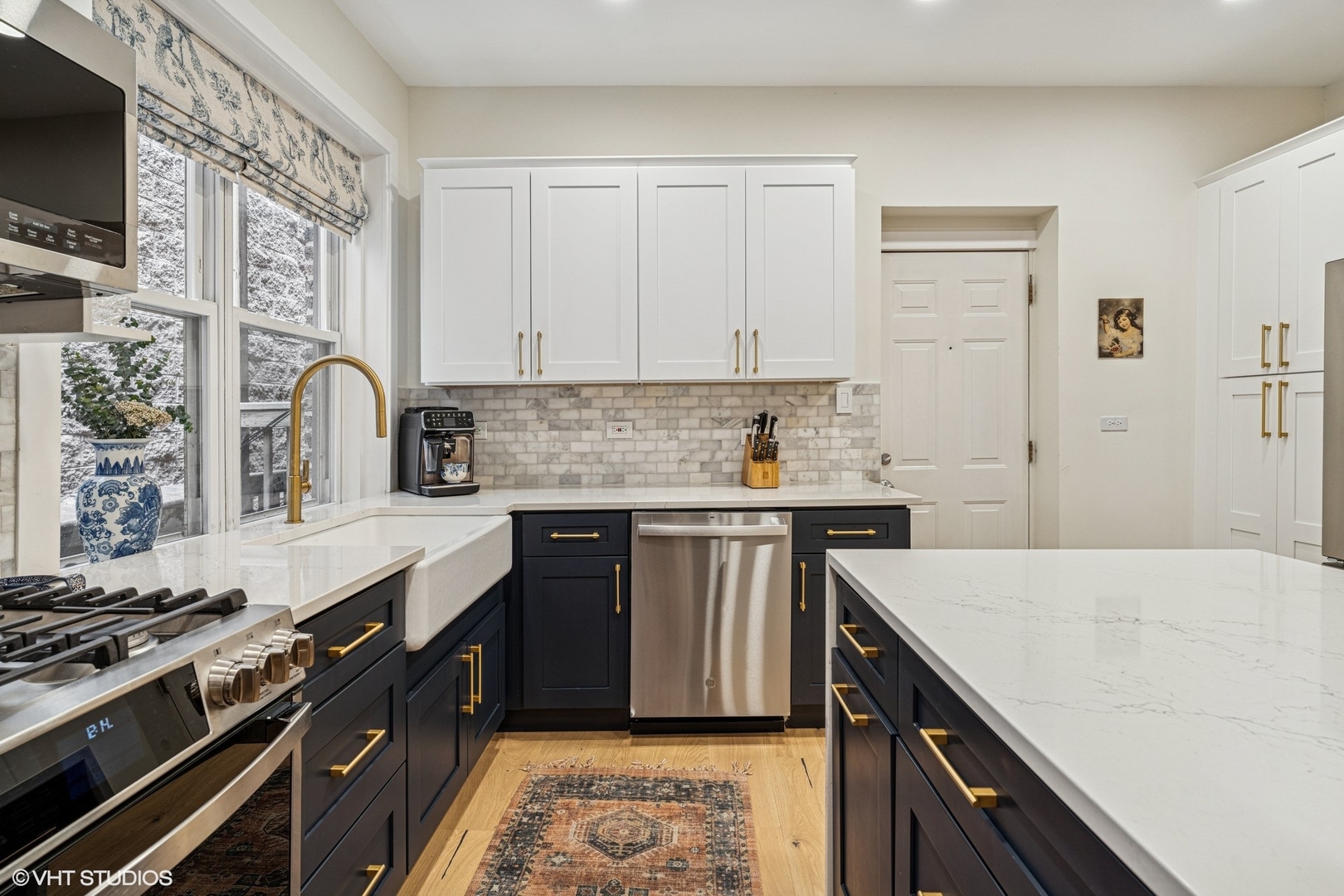 5103 North Clark Street, Unit 2 Chicago, IL 60640 - Photo 5 of 21 a kitchen with stainless steel appliances granite countertop a stove a sink and a microwave