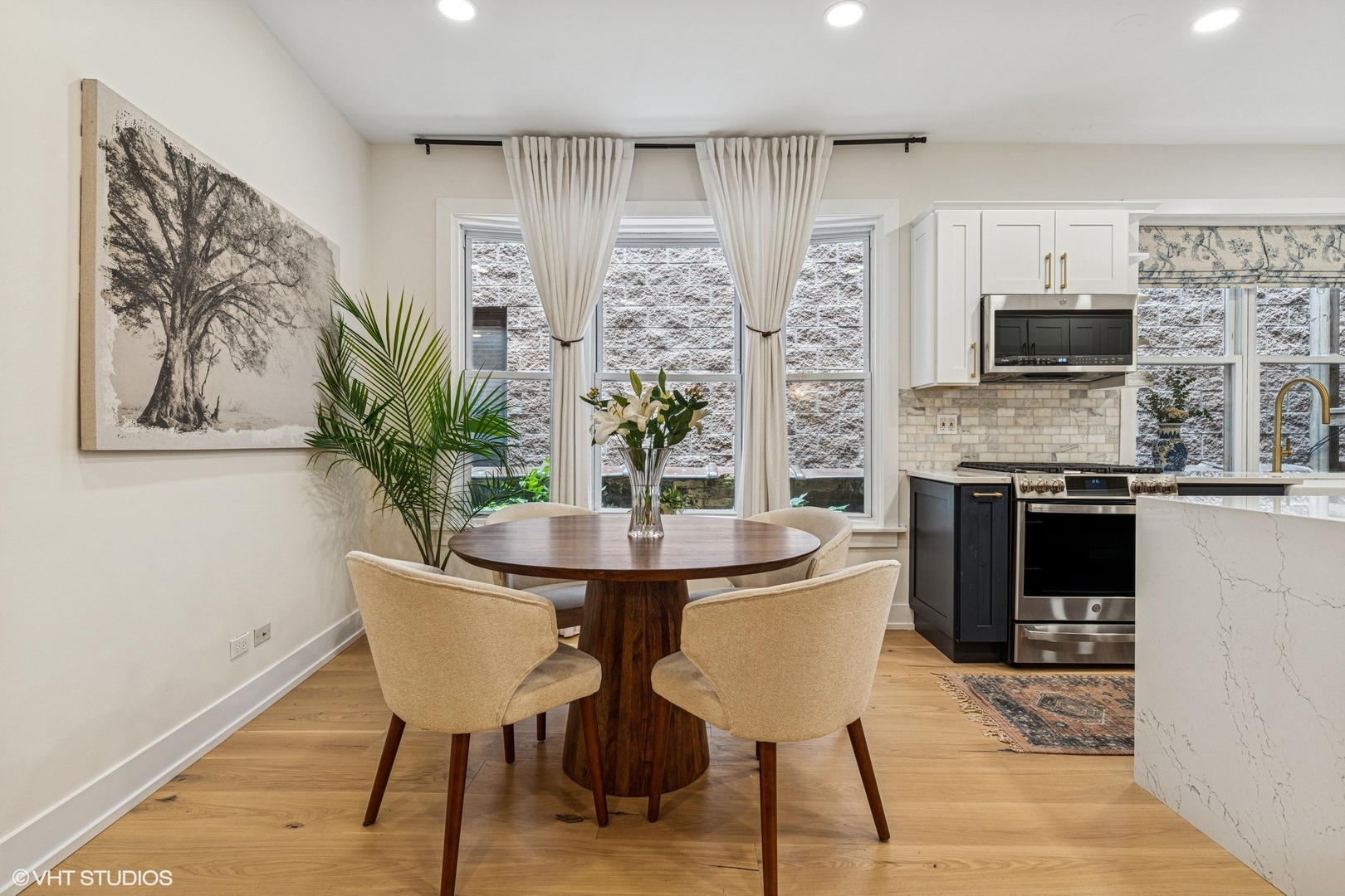 5103 North Clark Street, Unit 2 Chicago, IL 60640 - Photo 6 of 21 a view of a dining room with furniture and a kitchen
