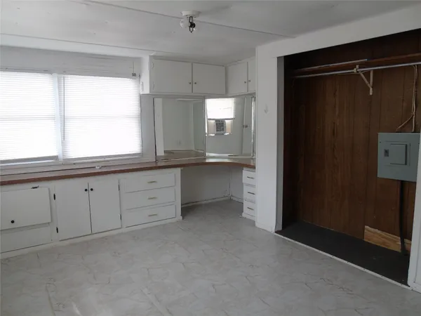 a view of a kitchen with window and cabinet