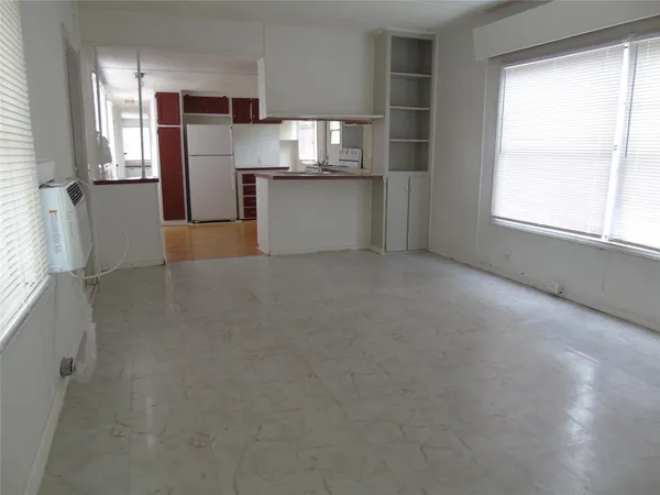 a view of a kitchen with a sink and refrigerator