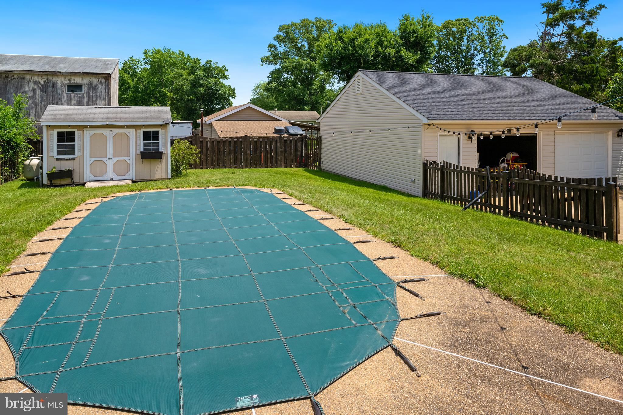 10303 Abbott Road Manassas, VA 20110 - Photo 32 of 36 a view of a house with a swimming pool and a yard