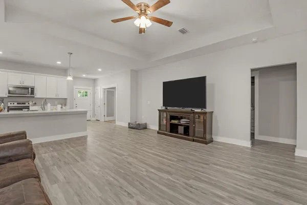 a view of kitchen with microwave and cabinets