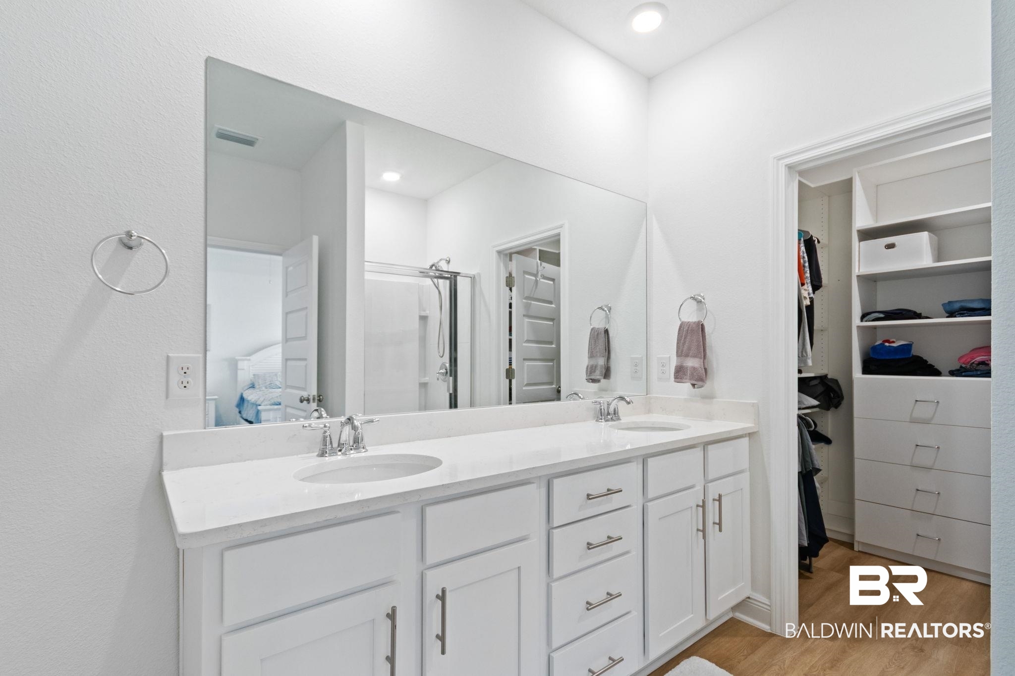 12919 Torrent Road Fairhope, AL 36532 - Photo 33 of 74 Ensuite bathroom featuring double vanity, light wood-style flooring, a shower stall, and a walk in closet