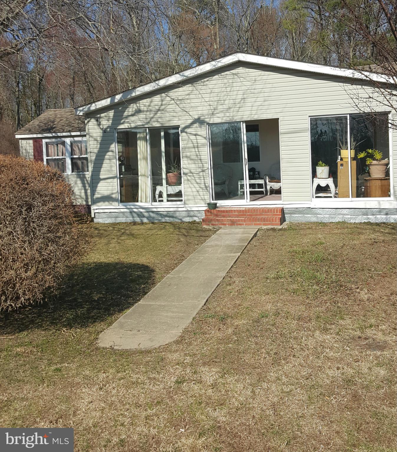 4890 Old Rte 50 Vienna, MD 21869 - Photo 1 of 3 a view of a white house with large windows and palm trees