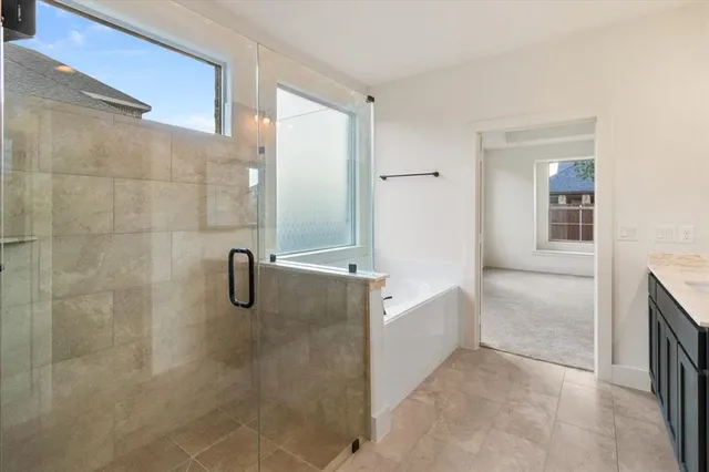 a bathroom with a bathtub and shower