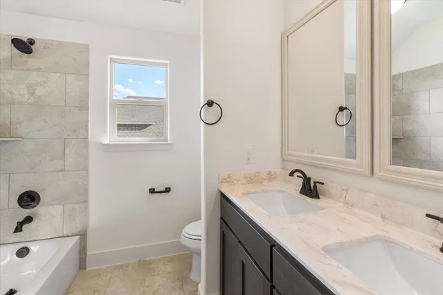 a bathroom with a sink a toilet a shower and a mirror