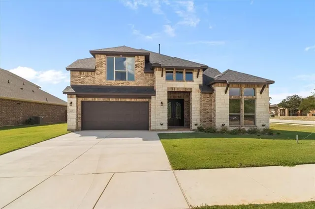 a front view of a house with a yard