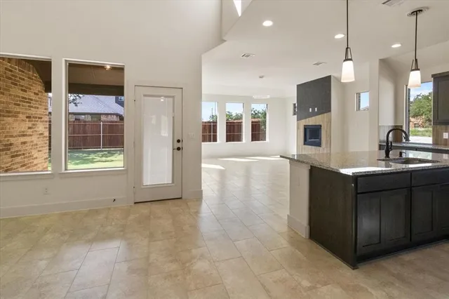 a living room with kitchen furniture and a sink