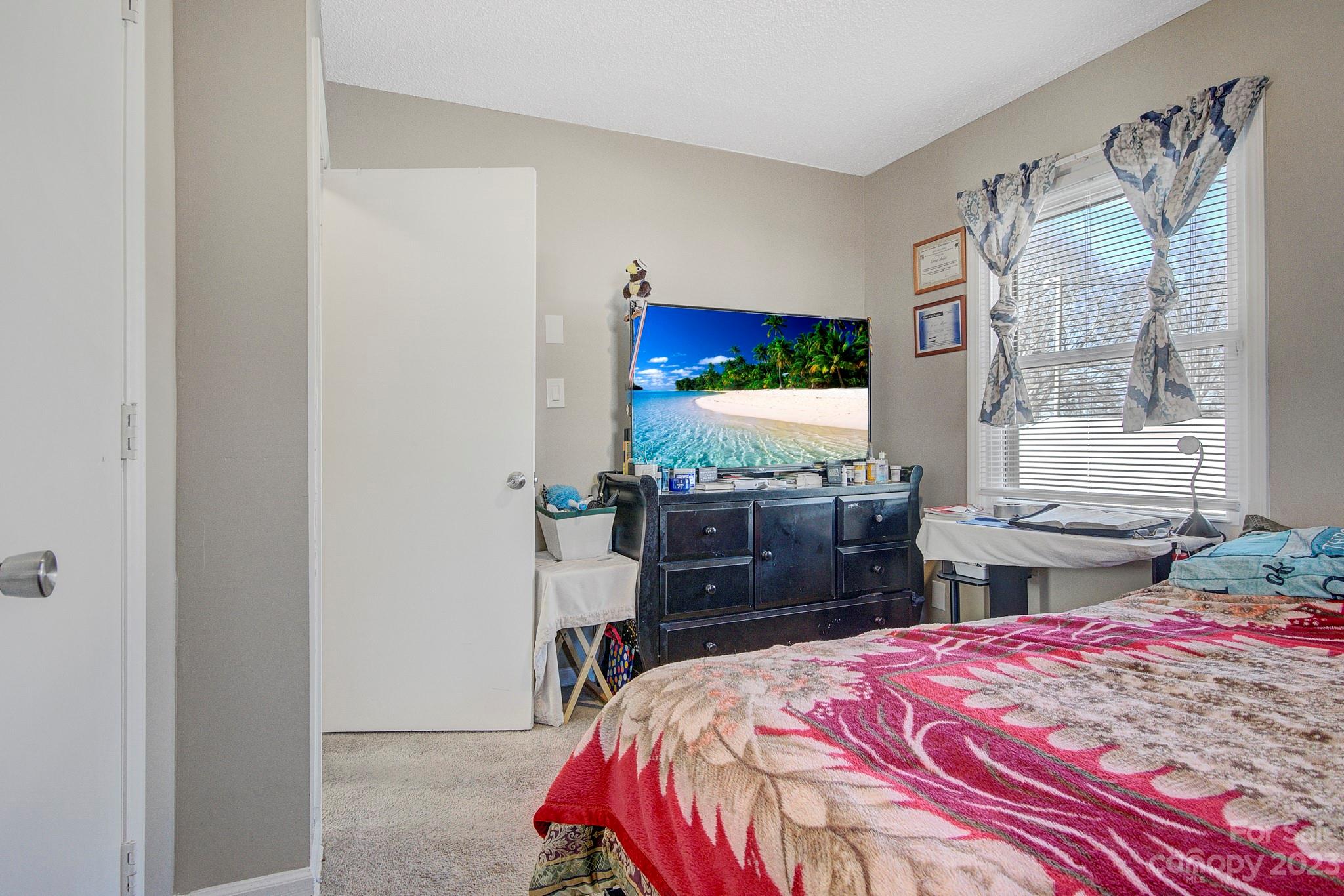 300 Newsome Road Salisbury, NC 28146 - Photo 18 of 27 a bedroom with a bed and a flat screen tv