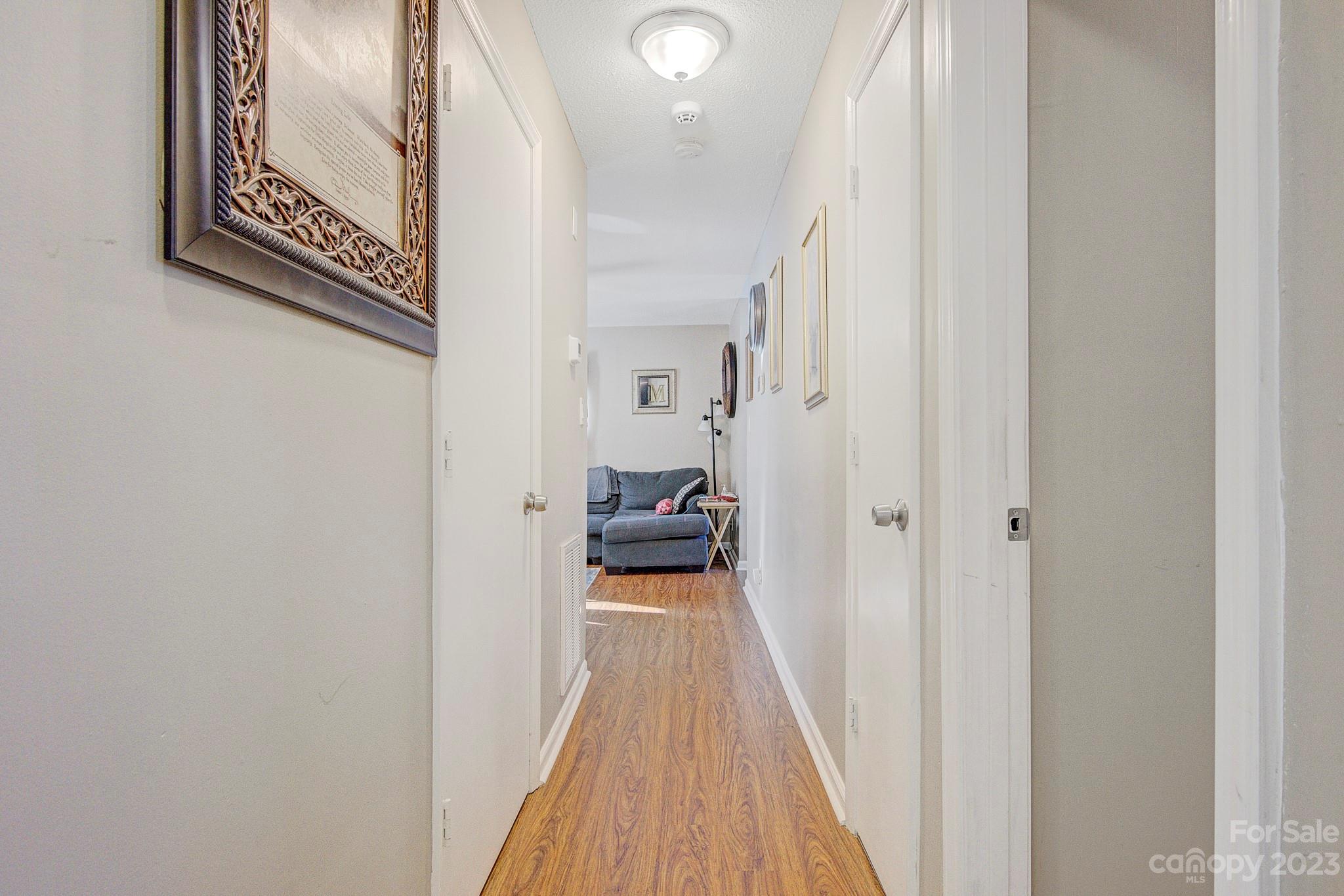 300 Newsome Road Salisbury, NC 28146 - Photo 23 of 27 a view of a hallway with wooden floor and a bathroom